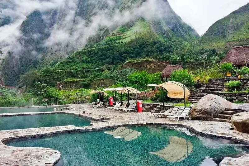 Cocalmayo outdoor pools, stone surrounds and green mountain slopes in February 2021