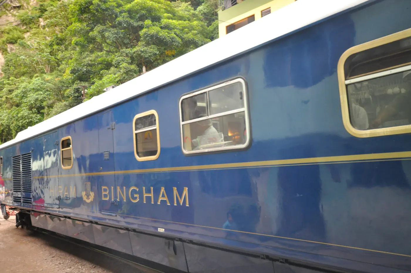 Blue-and-gold Hiram Bingham train carriage with its name and crest visible
